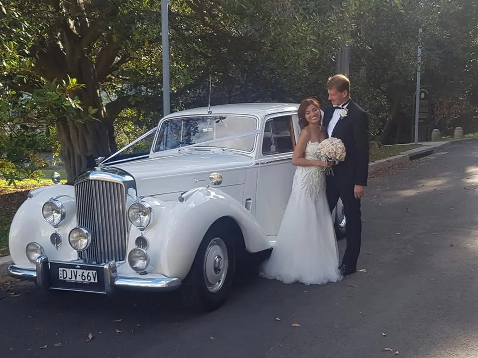 Wedding couple beside super stretch car