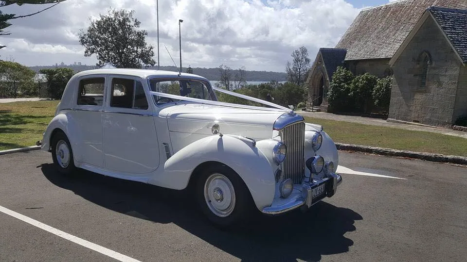 Long angle of white super stretch wedding car