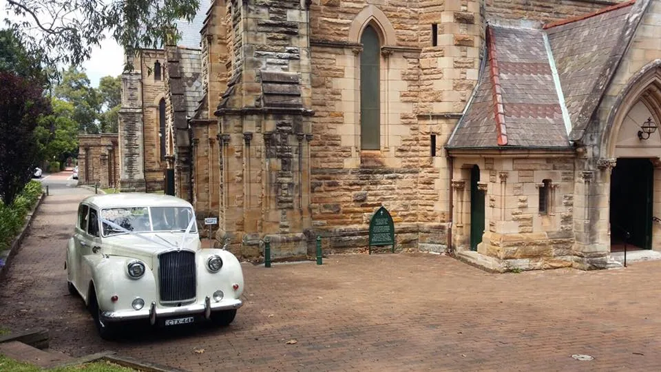 White Princess wedding car outside a church