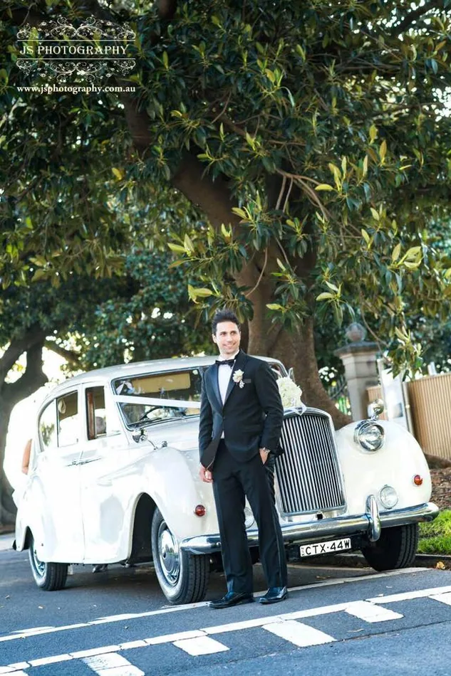 Wedding party beside Austin Princess wedding car