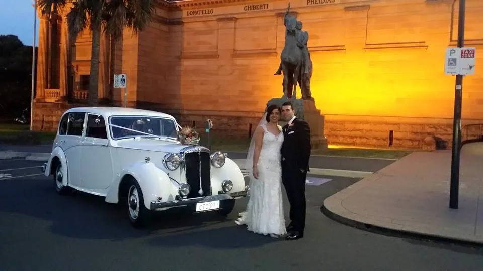 White Bentley wedding car at dusk