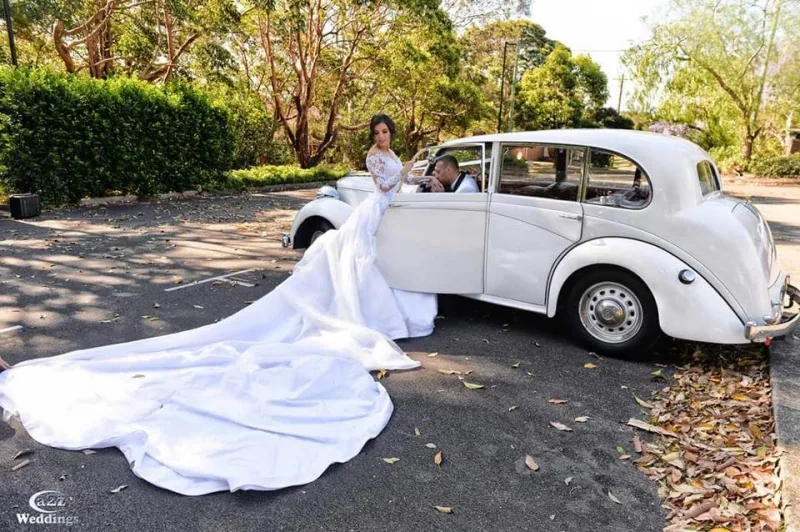 White Chrysler Dolly wedding car