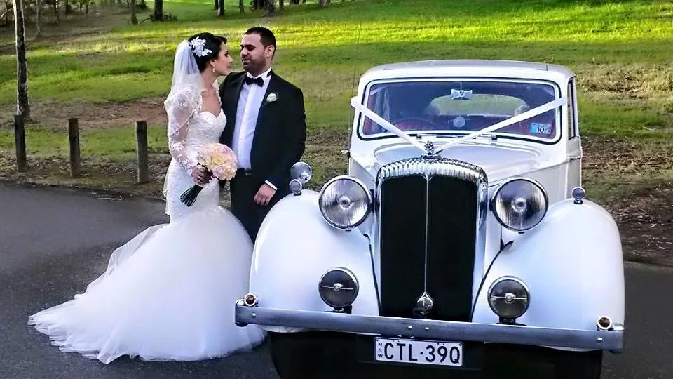 White Chrysler wedding car in park