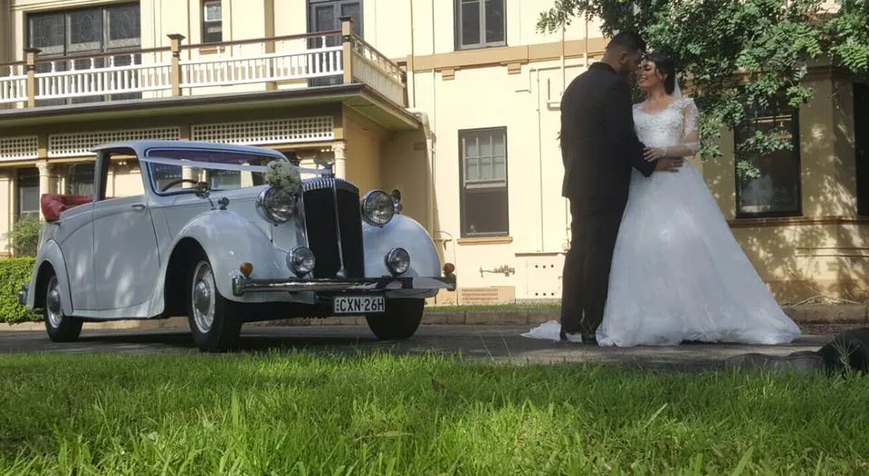 White convertible wedding car on grass