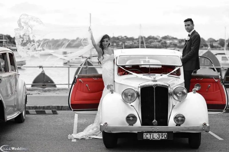 White Convertible Daisy parked for wedding photos