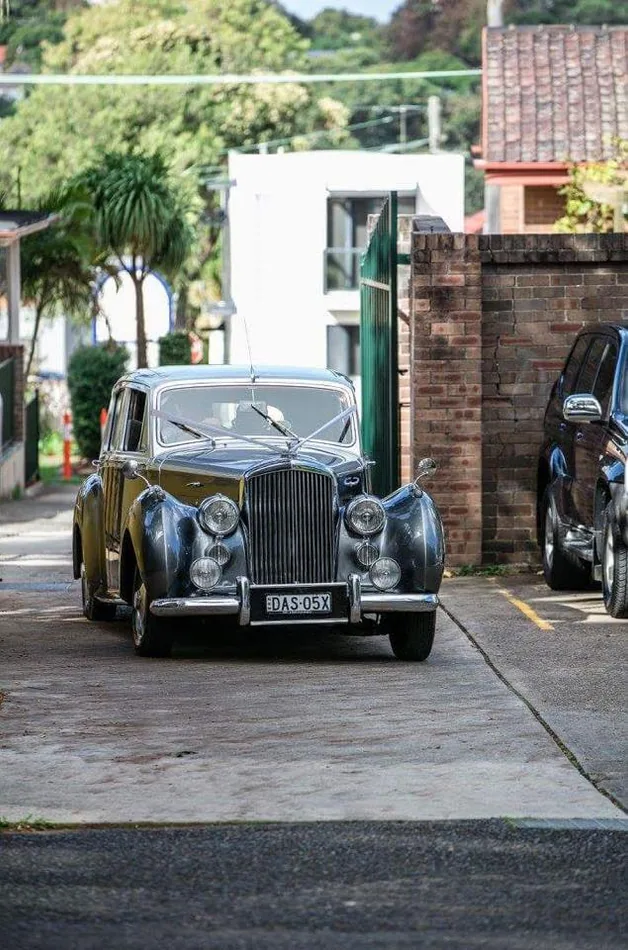 Silver Daimler wedding car on the road