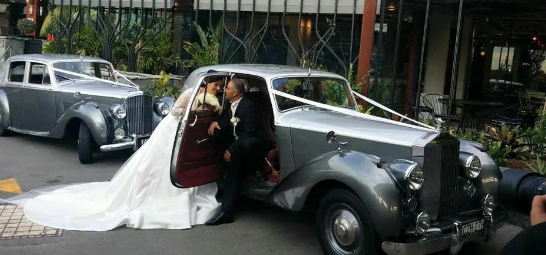 Wedding couple beside Silver Dawn