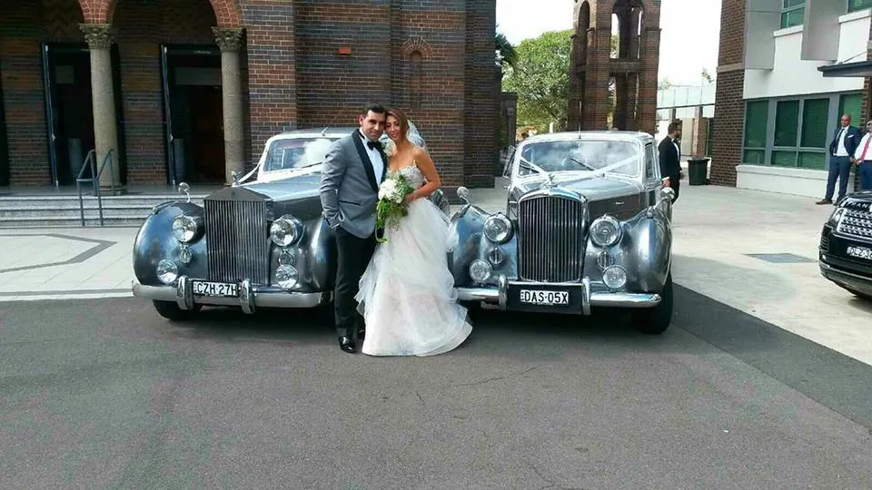 Two silver wedding cars together